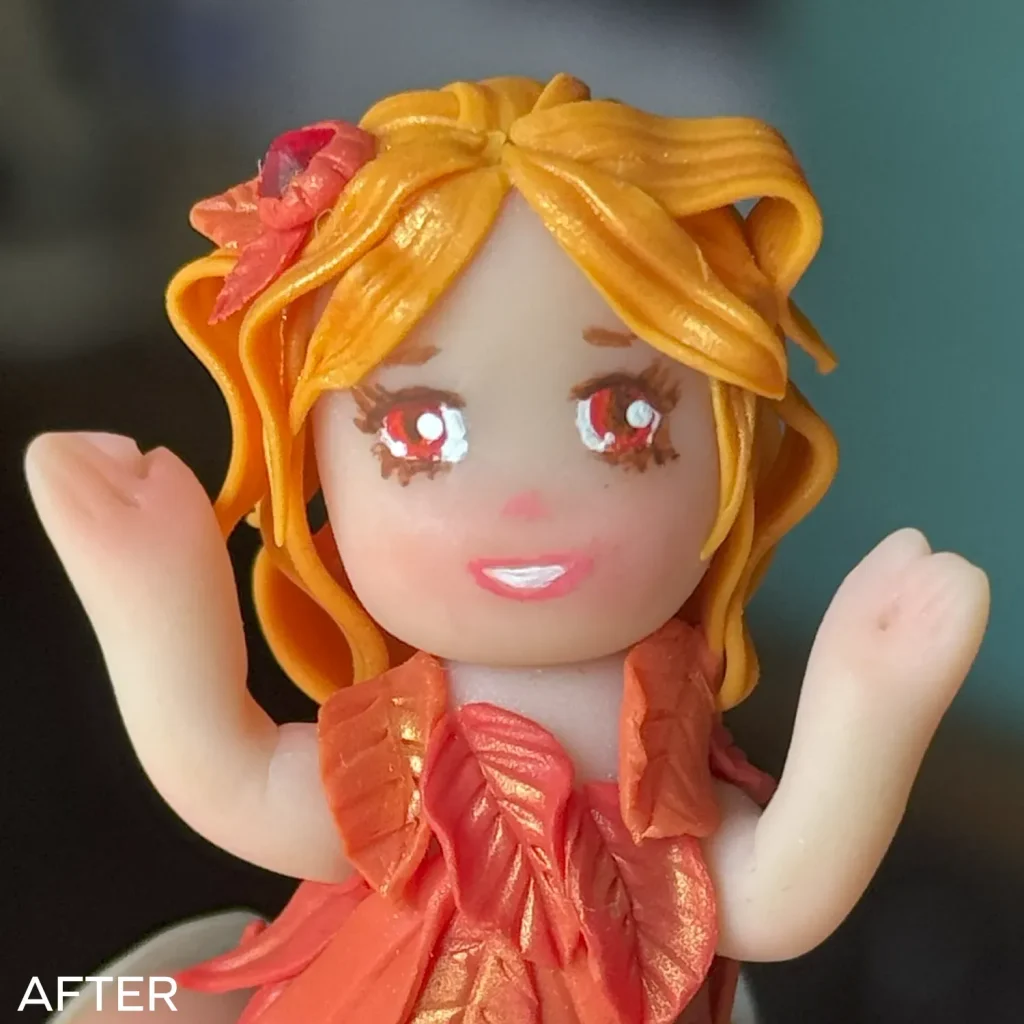 Close-up on fairy face after removing acrylic paint from polymer clay and repainting her face. Her mouth is smaller and symmetrical now. 